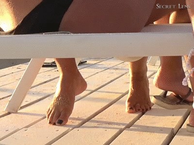 Bare Feet And Black Toenails On The Beach